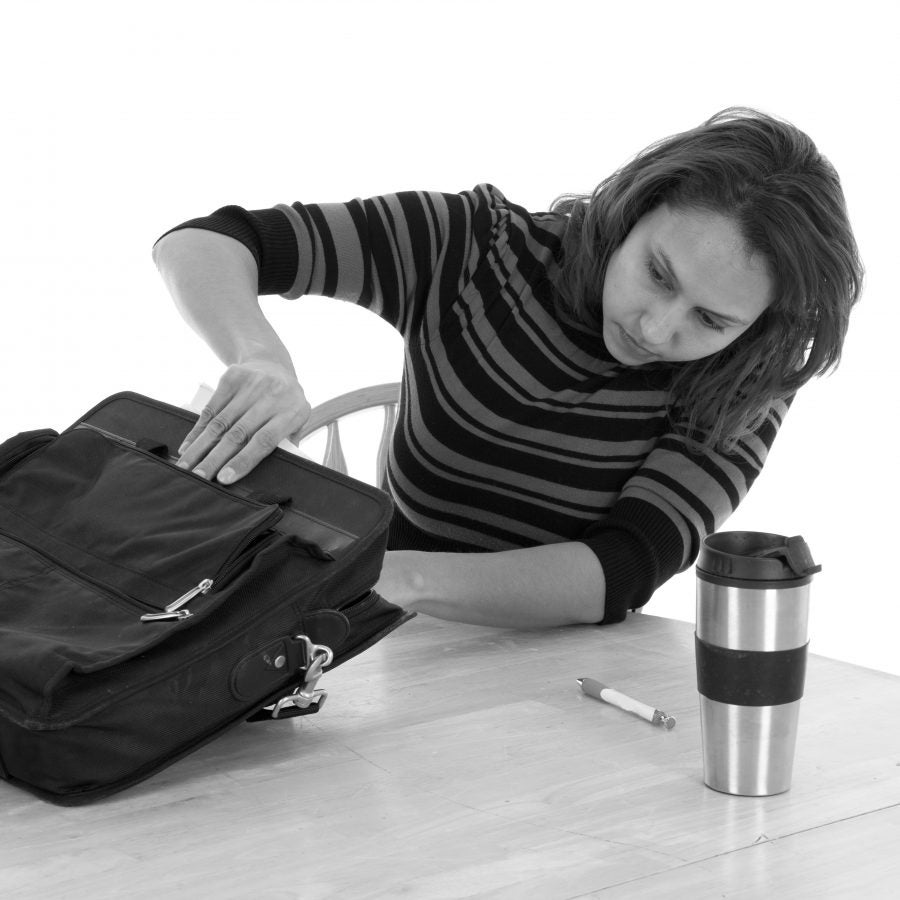 A woman is reaching into her bag.